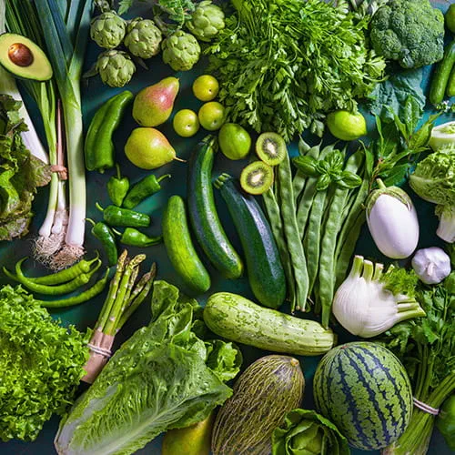 An assortment of green vegetables laid out on a table