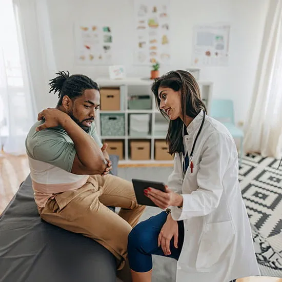 Doctor examining a patient's elbow