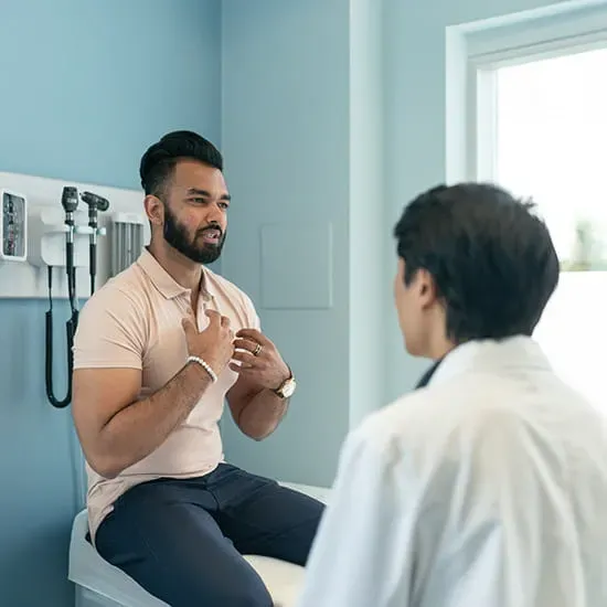 Doctor meeting with a patient who is describing pain in his chest