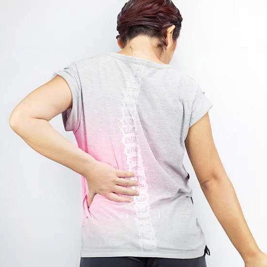 Woman holding her back with an illustration of a spine