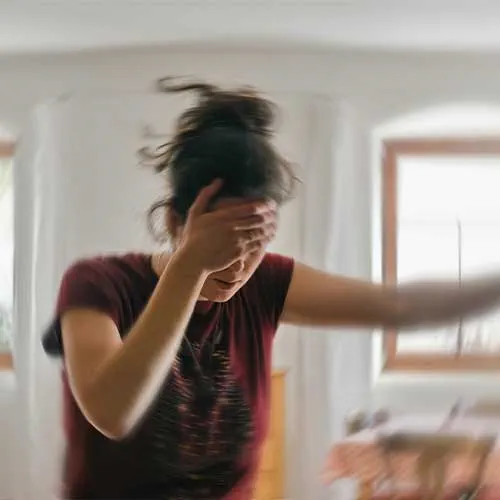 Woman suffering from vertigo or dizziness or other health problem of brain or inner ear.