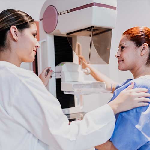 Doctor doing mammogram exam on patient at hospital