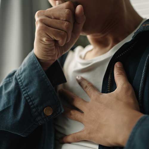 Young asian man was suffering from painful chest pain from a chronic disease.
