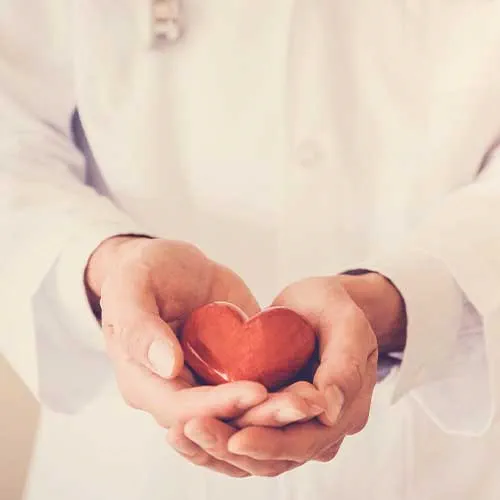 Doctor holding red heart with stethoscope, heart health, health insurance concept