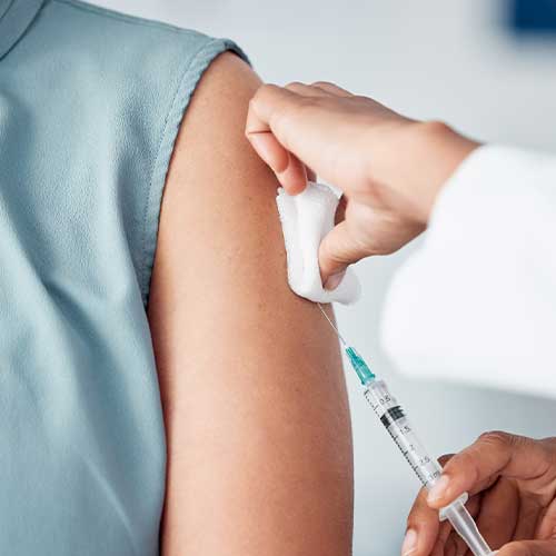 Hands, medical and doctor with patient for vaccine in a clinic for healthcare treatment for prevention. Closeup of a nurse doing a vaccination injection with a needle syringe in a medicare hospital.