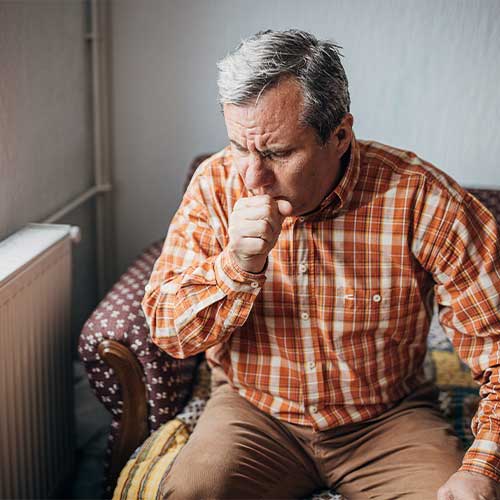 Ill senior man coughing