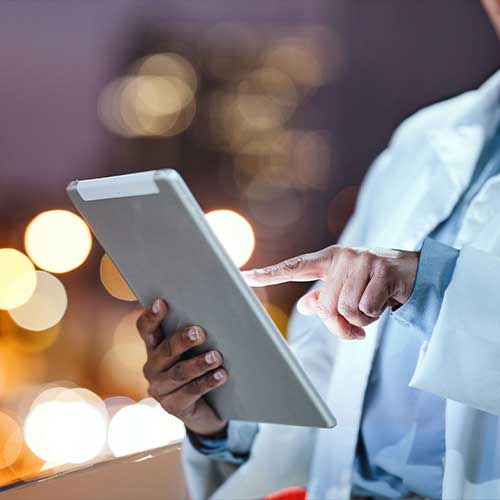 Hands, tablet and healthcare with a doctor doing internet research outdoor on a hospital balcony at night. Medical, remote consulting and technology with a medicine professional outside at a clinic