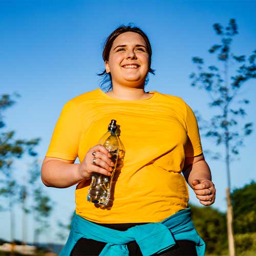 Young overweight woman running