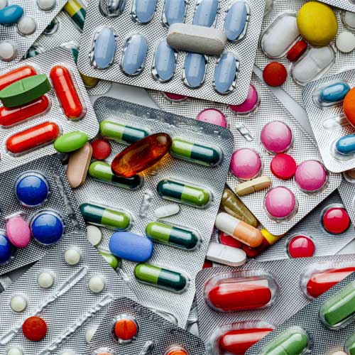 Background of a large group of assorted capsules, pills and blisters
