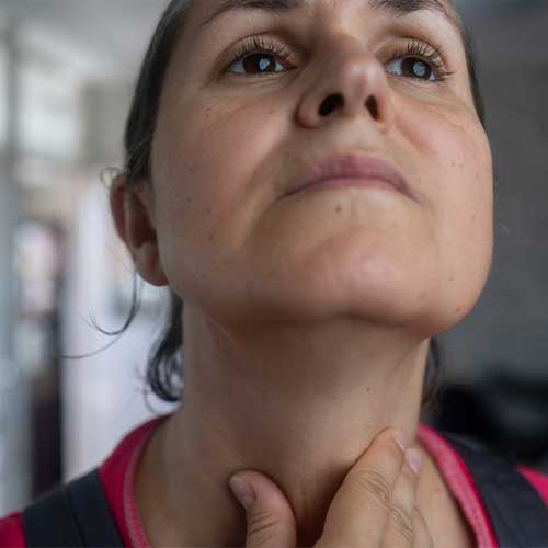 Woman thyroid gland control. Mature female sweeping the laryngeal, laryngitis, goiter or Hypothyroidism. Disorder of the endocrine system. Hashimoto’s Thyroiditis, Lymphocytic Thyroiditis.