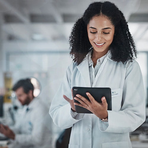 Doctor standing while looking at a tablet