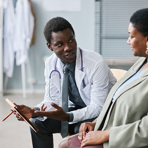 Doctor consulting female patient in clinic