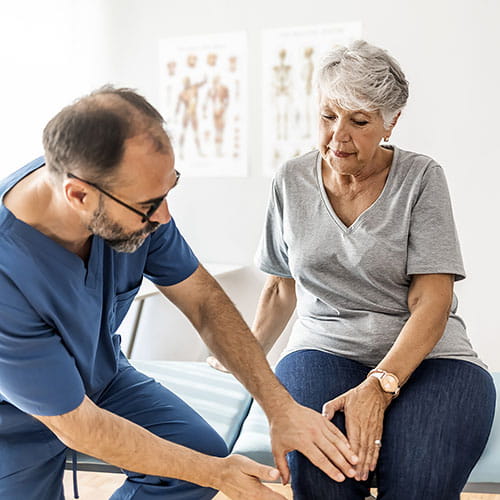 Doctor examining a patient's knee