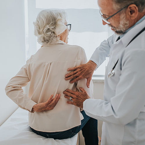 Doctor examining a patient's back