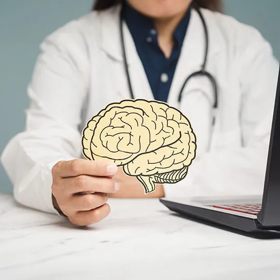 doctor holding image of brain