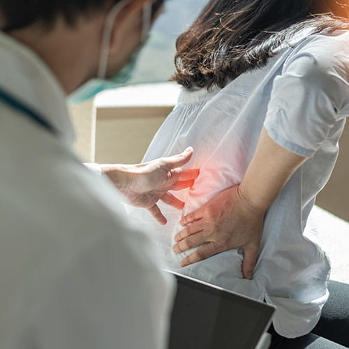 Doctor examining a patients back