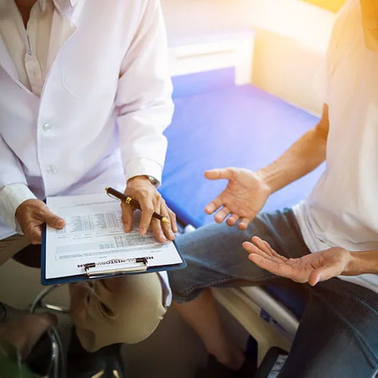 clinician speaking with a male patient