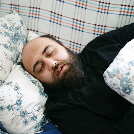 man sleeping on couch