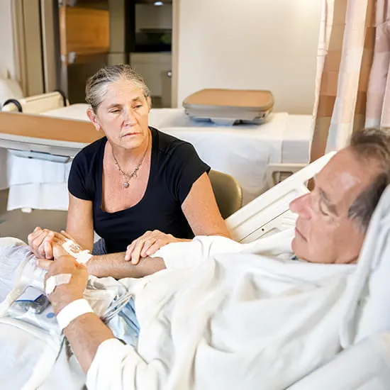 woman at mans hospital bedside