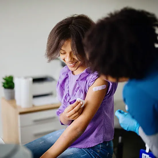 pre-teen girl getting a vaccine