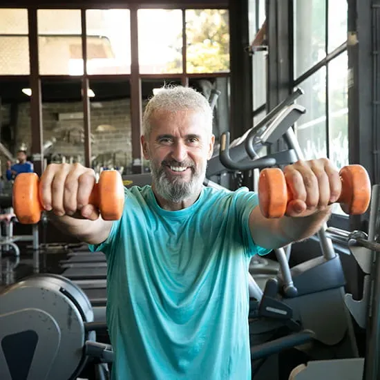 middle aged man lifting dumbbells