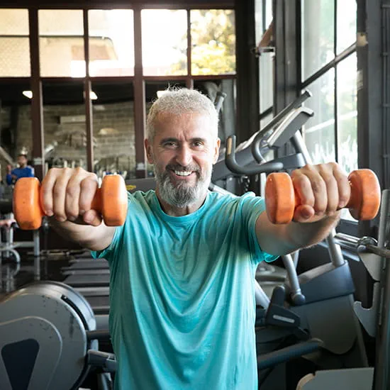middle aged man lifting dumbbells