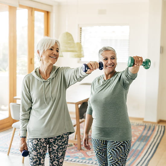 two older women lifting weights