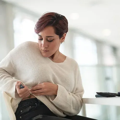 Woman injecting herself with insulin