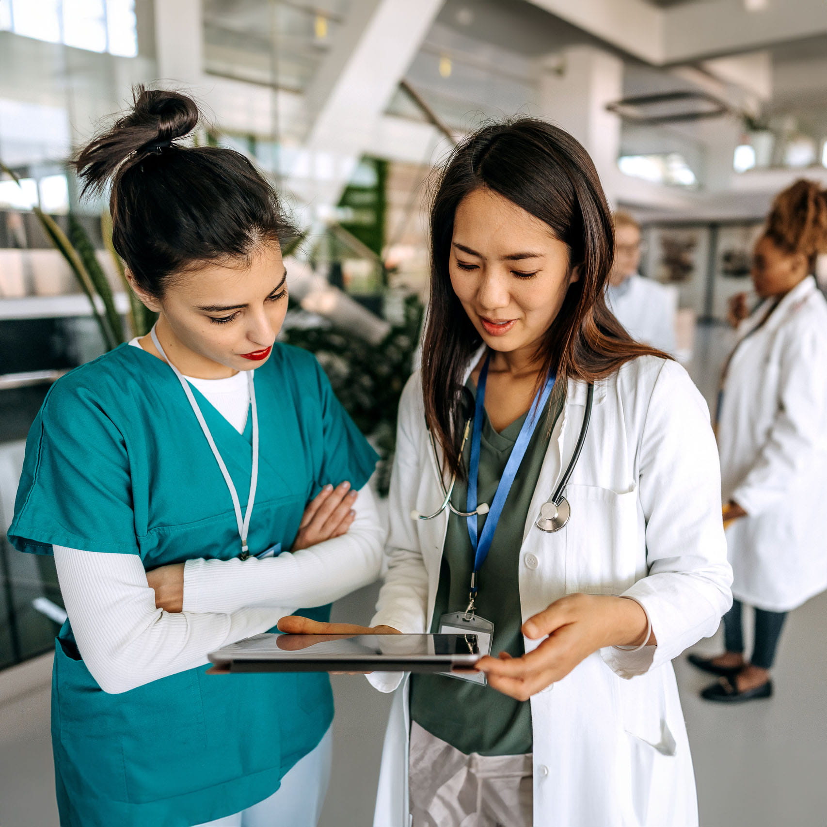 Two med students looking at a tablet