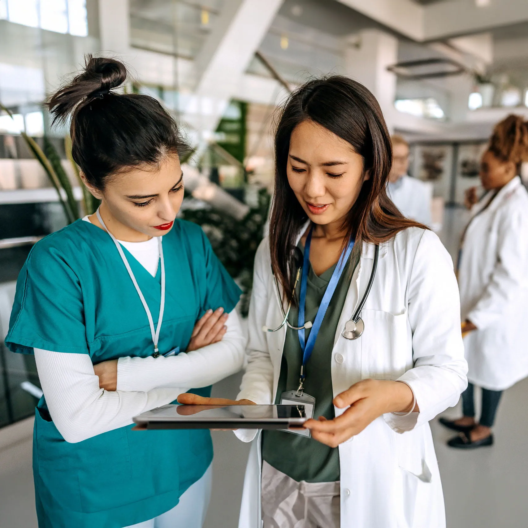 Two med students looking at a tablet