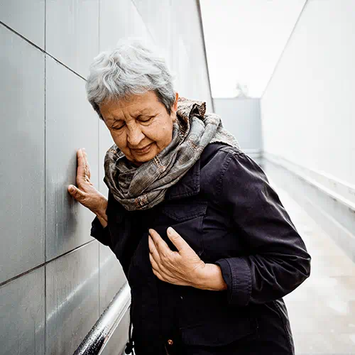 elderly woman clutching her chest