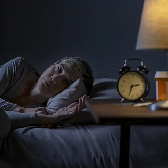person insomnia clock pill bottle