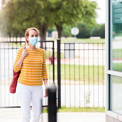 Woman wearing face mask walking outside