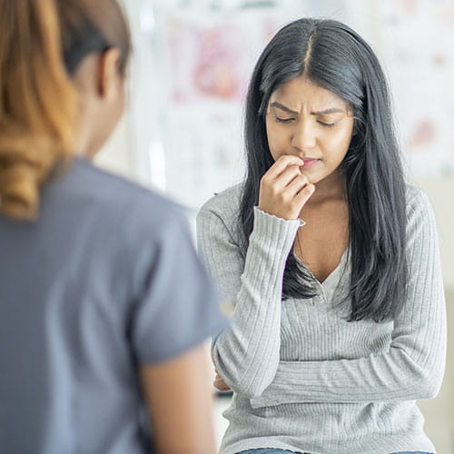 Sad looking woman meeting with a medical professional