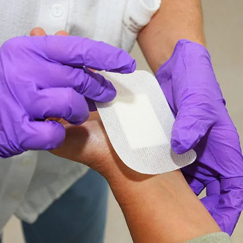 Patient receiving a bandage on their hand