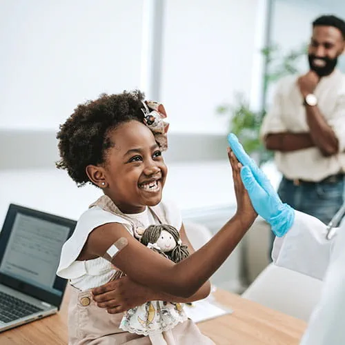 Girl high fiving a doctor