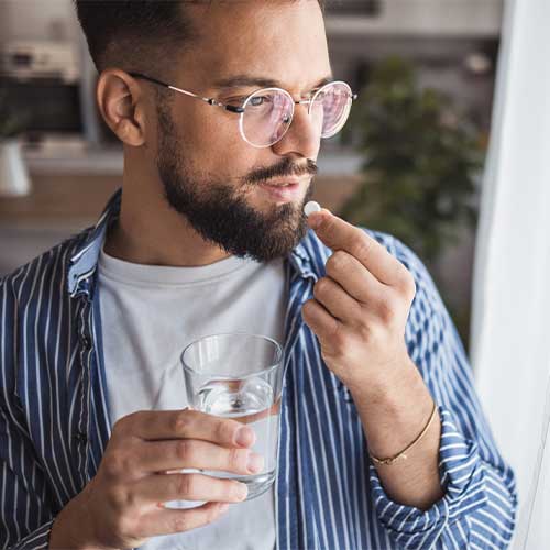 Morning care ritual - a moment of attention for yourself with a glass of water and a vitamin