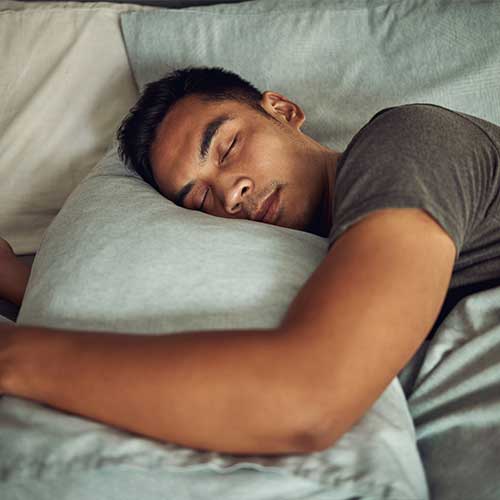 Shot of a young man sleeping peacefully in bed at home