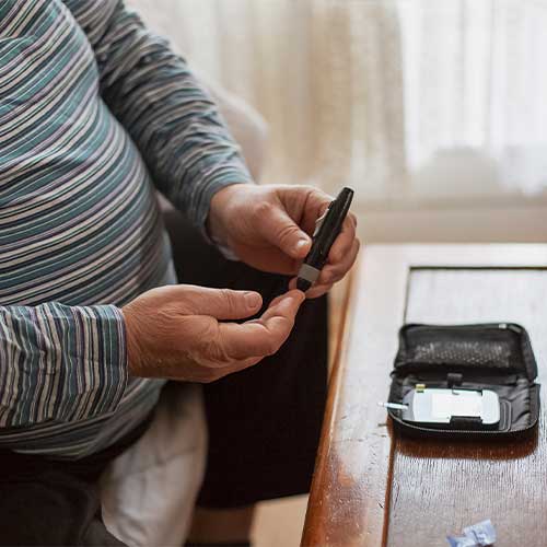 Senior man checking blood sugar levels