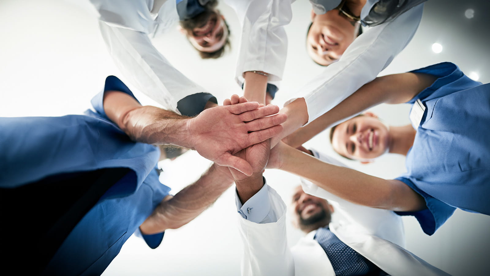 Medical workers putting their hands in