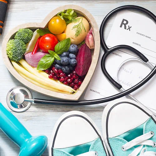 Heart filled with fruits and vegetables with a stethoscope wrapped around it