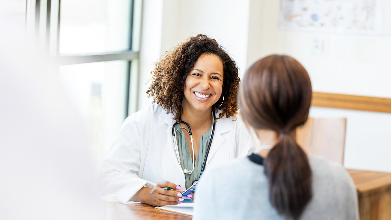Smiling doctor meeting with a patient