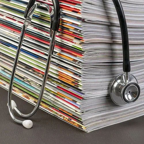 Stethoscope resting on magazines