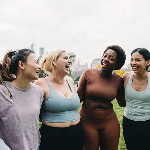 Friends shoulder to shoulder in a park