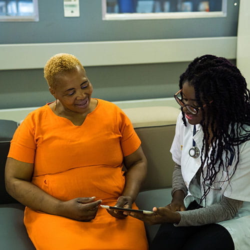 Doctor discussing medical results with a patient over a tablet