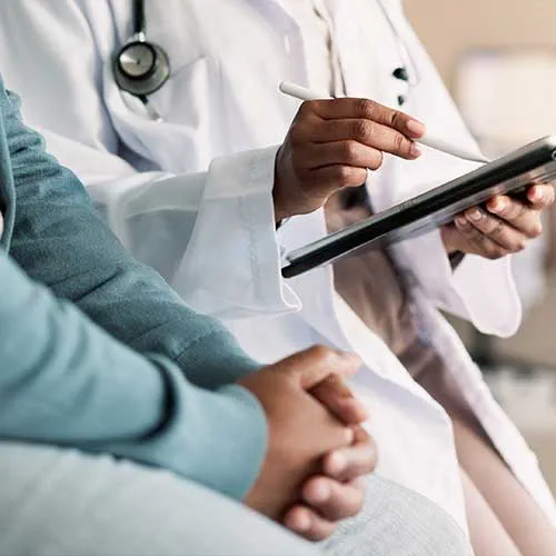 Tablet, hands and person with doctor for consultation with cold, flu and sickness symptoms. Digital technology, conversation and patient with healthcare worker for medical diagnosis in clinic.