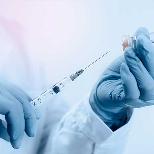 Hand holding syringe and medicine vial prepare