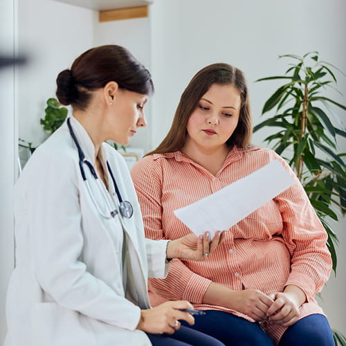 Doctor reading test results to a patient