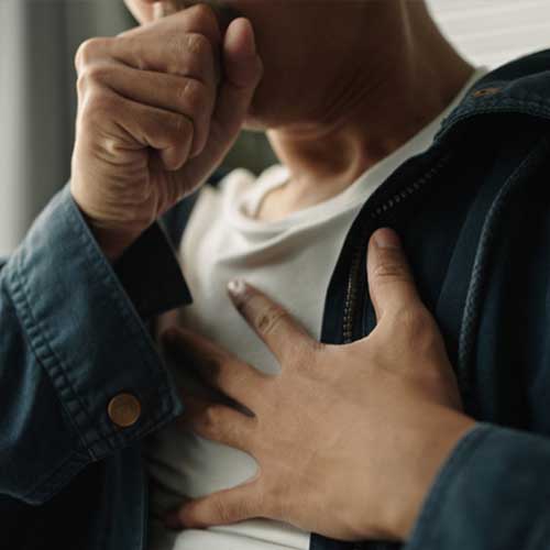 Young asian man was suffering from painful chest pain from a chronic disease.