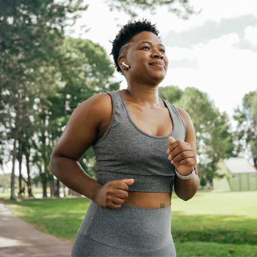 Woman running in the park with headphones